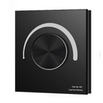 A black touch panel dimming switch with a central touch wheel and LED indicators.