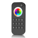 A black 3-in-1 remote control with a colorful LED indicator light on the top, and buttons labeled with various RGB and CCT colors.