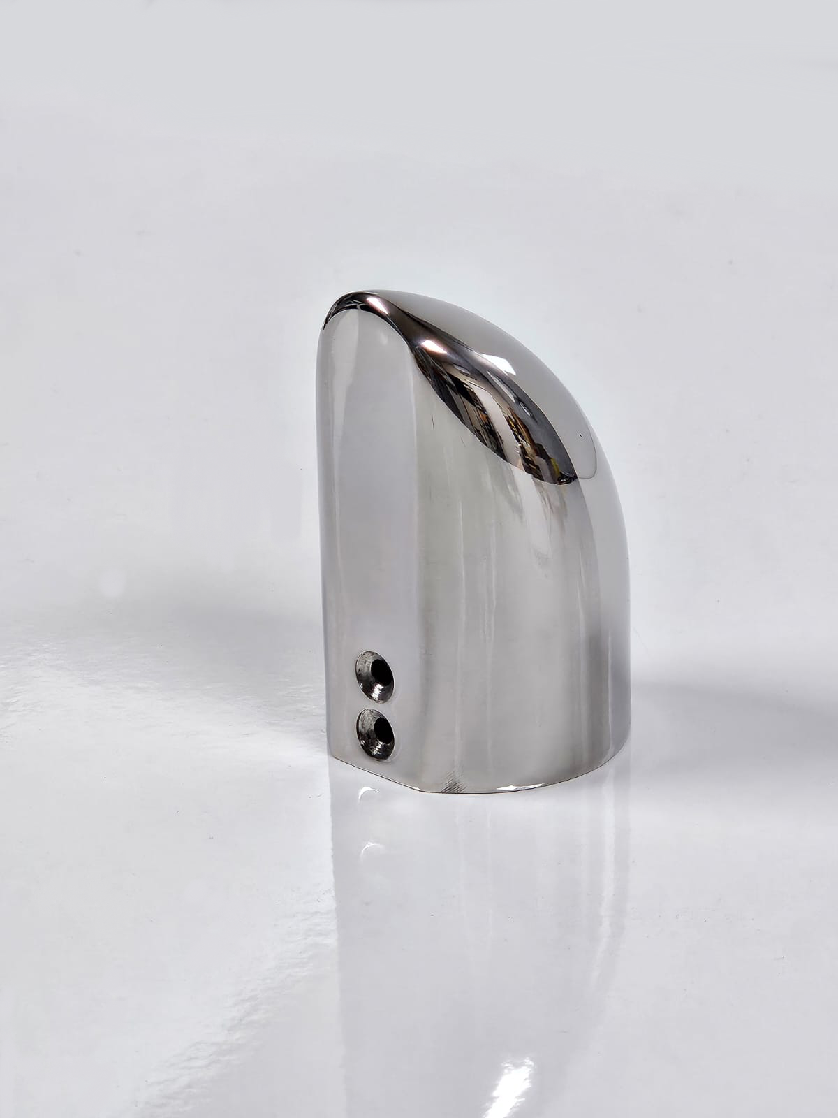 A silver-coloured metal end cap with visible screws on the side, placed against a white background.