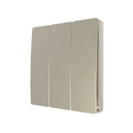 A gold three gang wall-mounted light switch