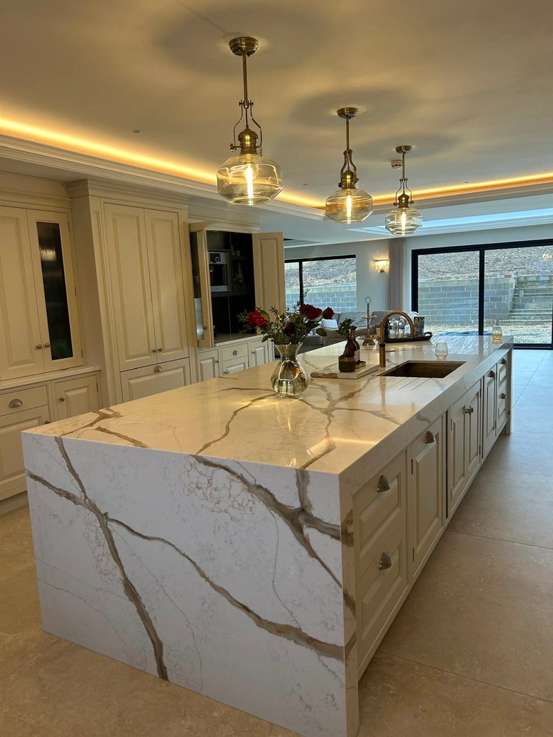 Modern kitchen with marble island and pendant lights