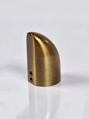 A gold-coloured metal end cap with visible screws on the side, placed against a white background.