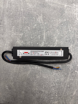 LED waterproof power supply driver on a gray textured surface