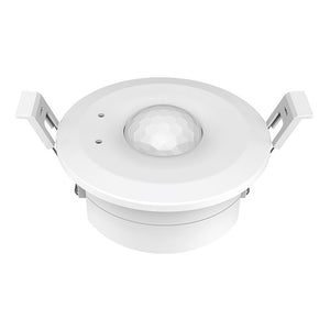 A white, ceiling-mounted PIR sensor with a visible sensor lens in the center and four mounting holes around the perimeter.