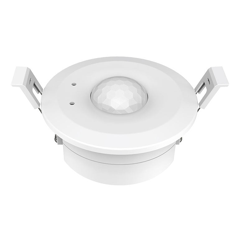 A white, ceiling-mounted PIR sensor with a visible sensor lens in the centre and four mounting holes around the perimeter.