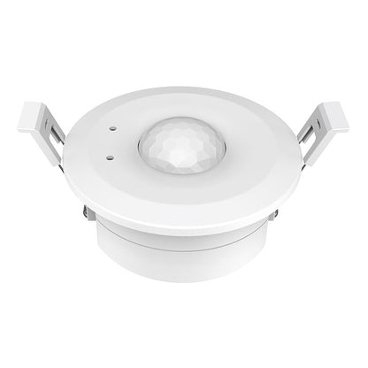 A white, ceiling-mounted PIR sensor with a visible sensor lens in the centre and four mounting holes around the perimeter.