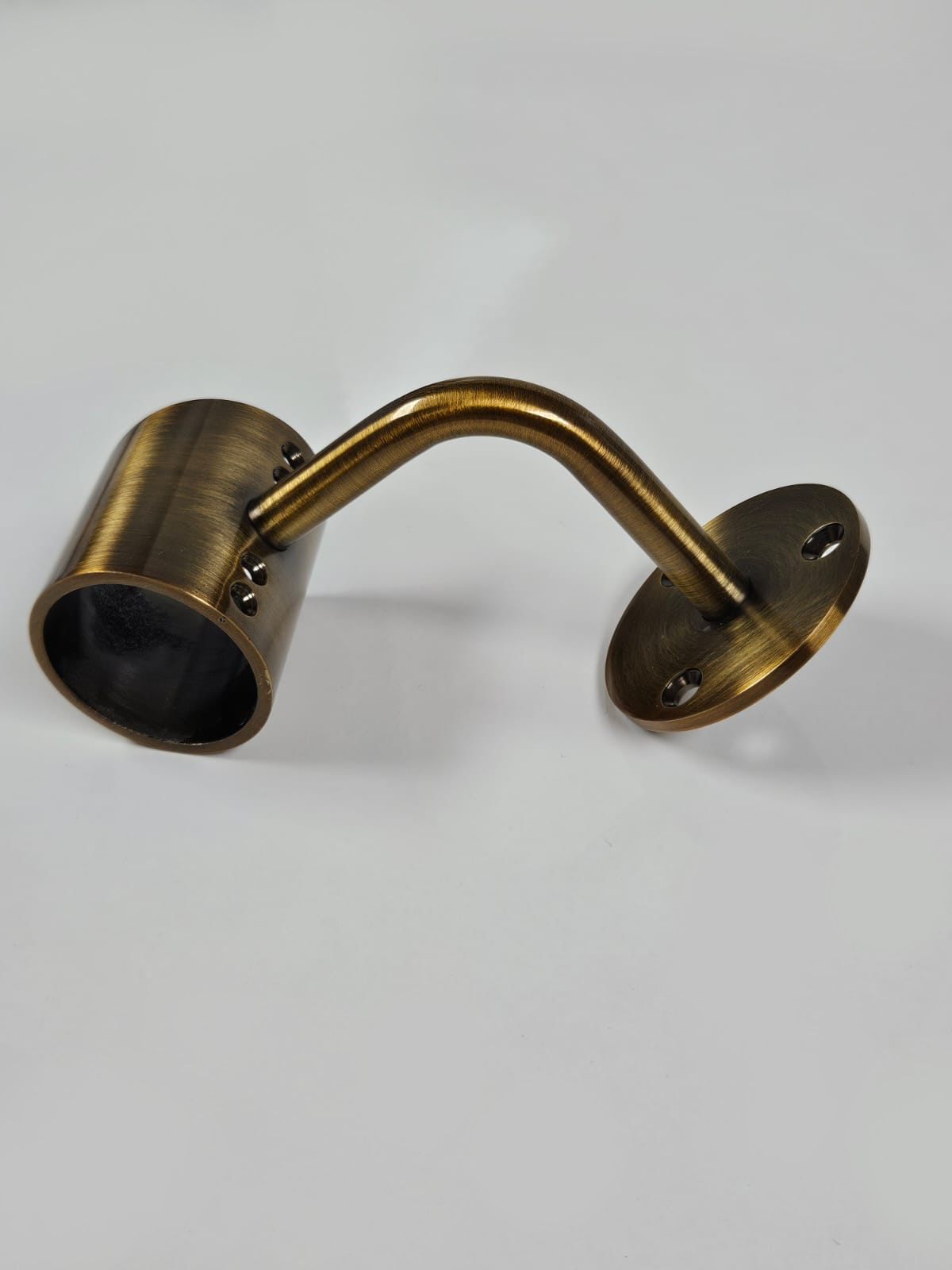 A gold metal bracket with a cylindrical extension on one end, placed against a white background.