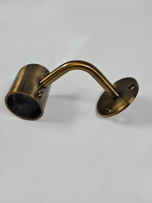 A gold metal bracket with a cylindrical extension on one end, placed against a white background.