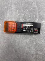Electrical component with SELV marking on a gray surface