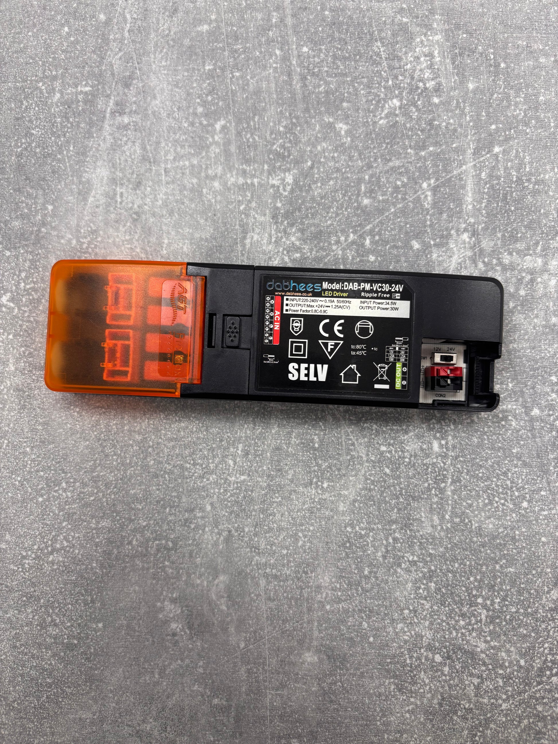 Electrical component with SELV marking on a gray surface