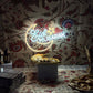 Eid Mubarak Neon sign on a floral wallpapered wall.