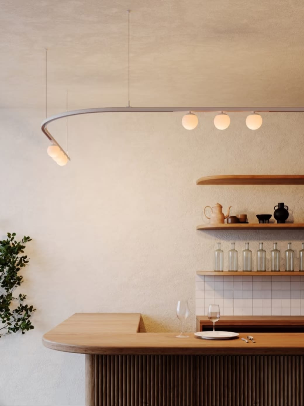 Modern interior with a wooden counter, shelves with decor items, and a hanging light fixture.