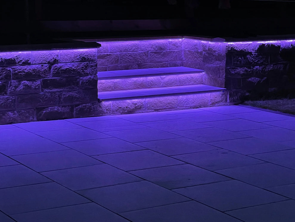 Garden stairs featuring a purple LED light under the stairs.