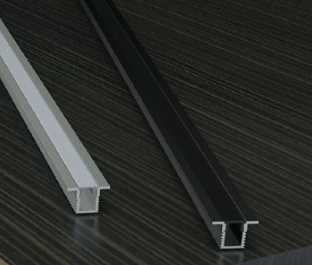 Metallic U-shaped profile on a dark wooden surface