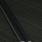 Metal profile on a dark wooden surface