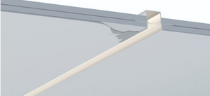 Close-up of a metal profile with a reflective surface on a light gray background