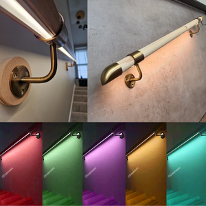 The image shows a LED handrail lighting kit installed on a staircase. The handrail is pine and has integrated LED lights under it, giving a discreet and uniform illumination.
