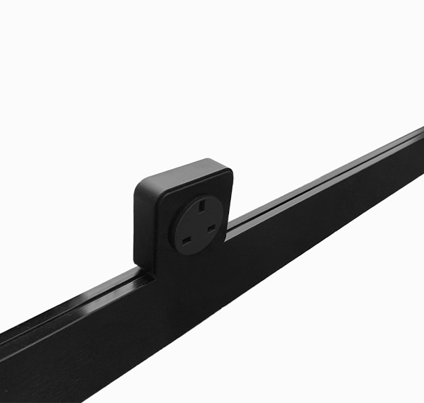 A black power track attached to charging port with a white outline around the socket holes, set against a white background.