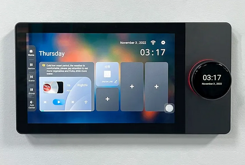 A digital home automation control panel with a touchscreen interface displaying various menu options such as lighting and voice control, with a time and date display at the bottom.