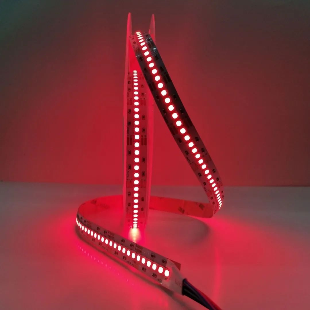 Red LED strip light on a white surface with a red background