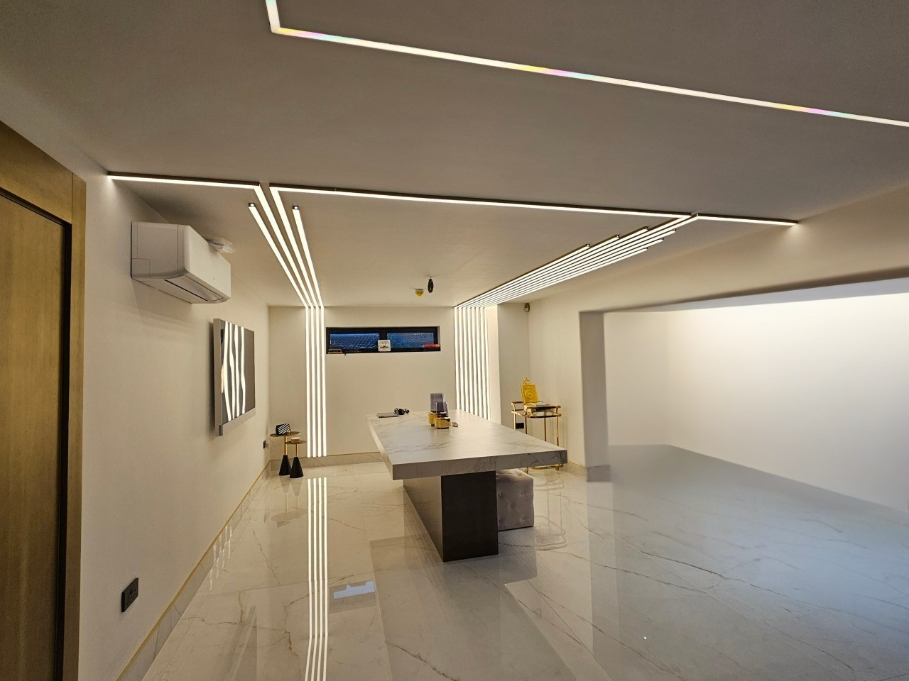 Modern office interior with a long desk, chairs, and decorative elements.